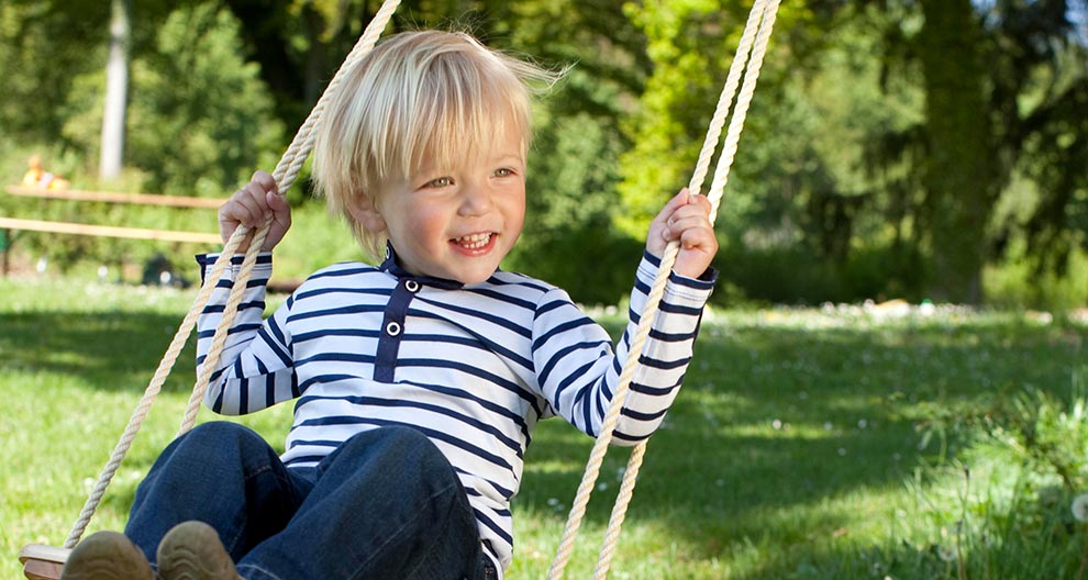 A child swings in a park.