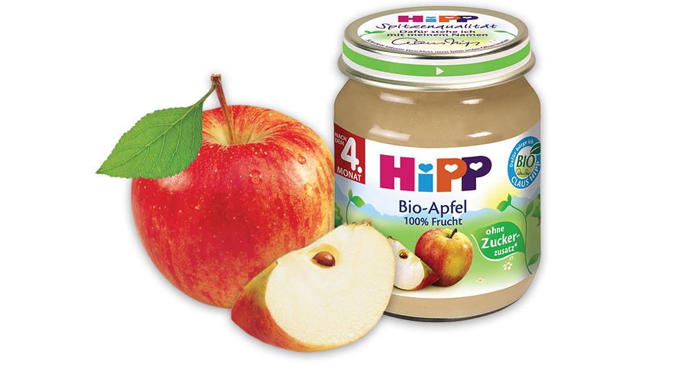 An apple and a jar of apple puree are displayed.
